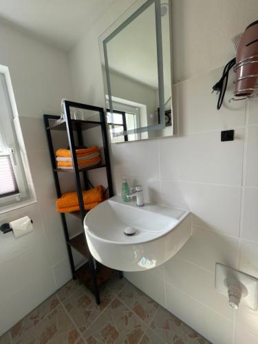 a bathroom with a white sink and a mirror at Ferienwohnung Levin in Dargun