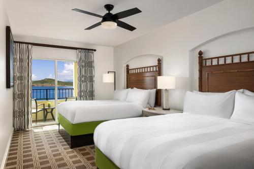 ein Hotelzimmer mit 2 Betten und einem Balkon in der Unterkunft Marriott's Frenchman's Cove in Estate Thomas