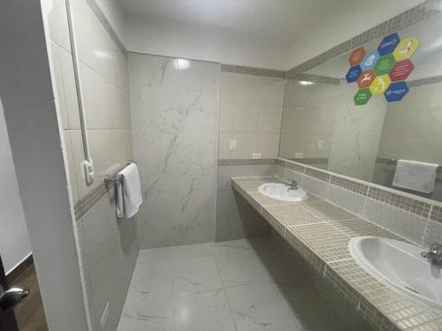 a bathroom with two sinks and a large mirror at (24)Dpto de estreno en el corazón de Miraflores in Lima