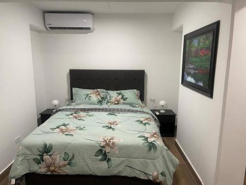 a bedroom with a large bed with flowers on it at (24)Dpto de estreno en el corazón de Miraflores in Lima