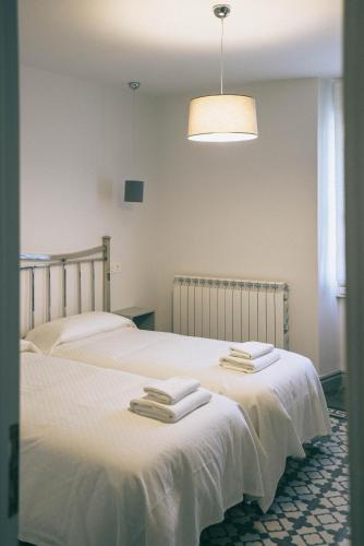 a bedroom with two beds with towels on them at Casa Montero in Viniegra de Abajo