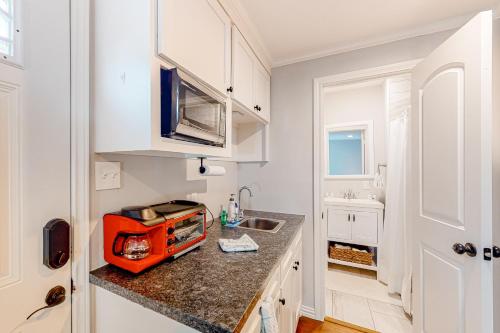 a kitchen with an orange appliance on a counter at The Heights Garden Cottage in Houston