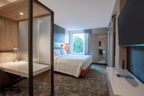 a hotel room with a bed and a desk at SpringHill Suites by Marriott Chester in Chester