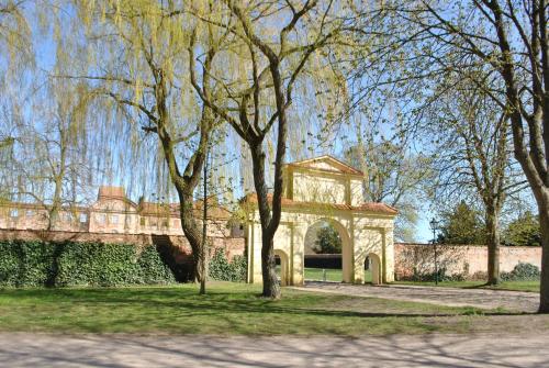 a stone archway in a park with trees at Ferienwohnung Levin in Dargun