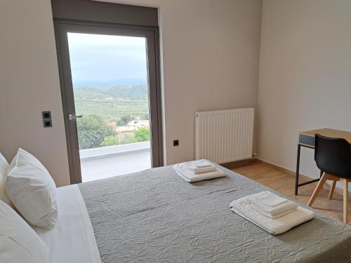 a bedroom with a bed with two towels on it at Christine luxury villa in Kolymvari