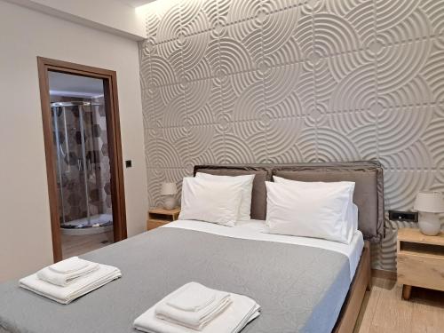 a bedroom with a bed with two towels on it at Christine luxury villa in Kolymvari