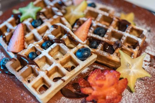 a plate of waffles with fruit on it at Fairfield by Marriott Medellin Sabaneta in Medellín