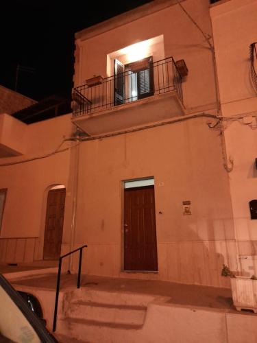 a building with a door and a balcony at La Coccola in Leporano
