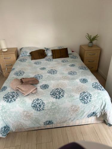 a bedroom with a bed with a blue and white comforter at Double room with shared facilities in London