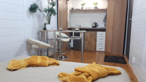 a kitchen with a bed with yellow towels on it at Penzión Florens, Nesvady in Nesvady