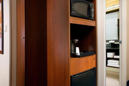 a room with a tv in a wooden closet at Fairfield Inn & Suites Germantown Gaithersburg in Germantown