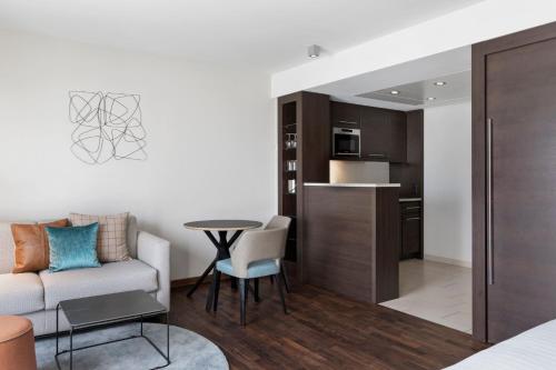 a living room with a couch and a table at Residence Inn by Marriott Munich City East in Munich