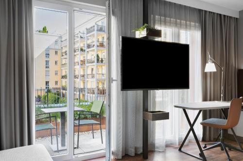 a room with a flat screen tv in a hotel room at Residence Inn by Marriott Munich City East in Munich