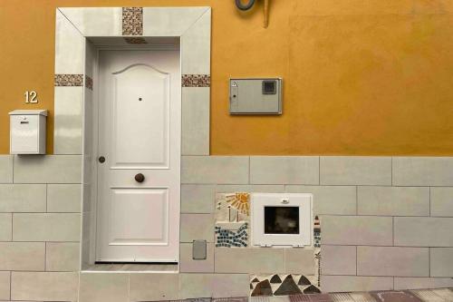 a room with a door and a microwave on a wall at Casa Brisa del mar in La Jaca