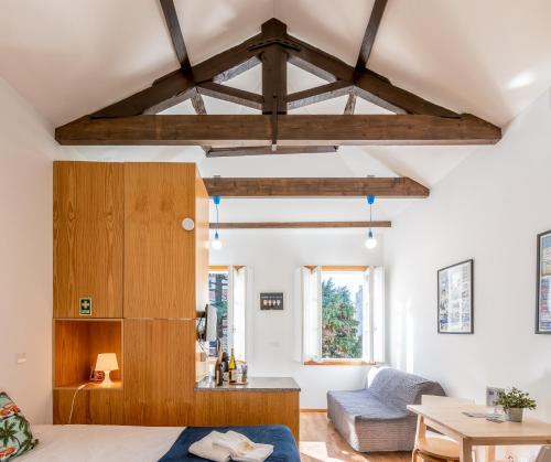 a living room with wooden beams and a couch at 733 Costa Cabral Metro Residence in Porto