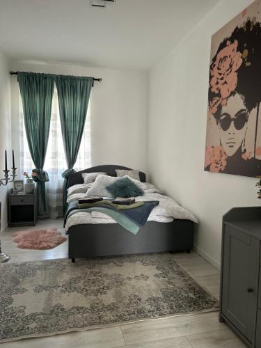 a bedroom with a bed with a rug and a window at Sophie’s Urban Nest in Miskolc