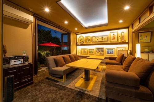 a living room with a couch and a table at Gallery NICO - Vacation STAY 93284v in Yaochō