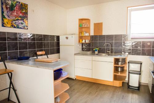 a kitchen with a white refrigerator and a sink at Ferienwohnung in Celle in Celle