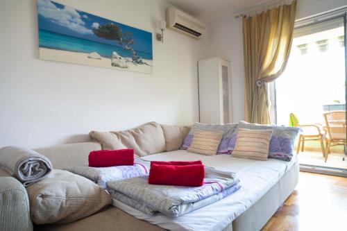 a living room with a couch with pillows on it at Apartman Adriatic Sea in Promajna