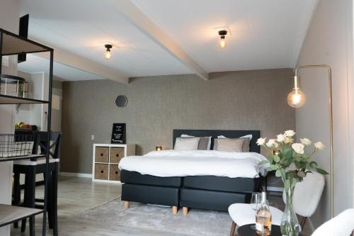 a bedroom with a bed and a living room at La Siesta Noordwijk Zee in Noordwijk