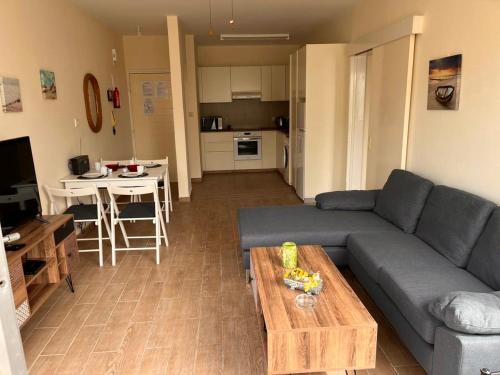 a living room with a couch and a table at Diamond Complex in Paphos City