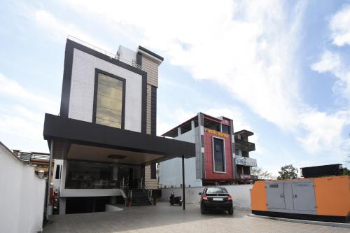 a modern house with a black and white facade at Yours Pacific in Jhājra