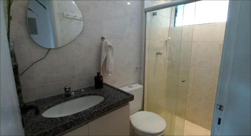 a bathroom with a sink and a toilet and a mirror at Studio Portal dos Corais apartamento 1003 in Recife