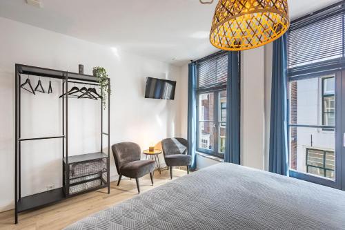 Postel nebo postele na pokoji v ubytování C'est la Vie Middelburg