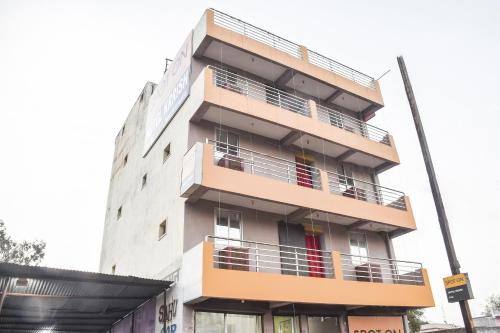 a building with balconies on the side of it at SPOT ON Hotel Krrish in Durg