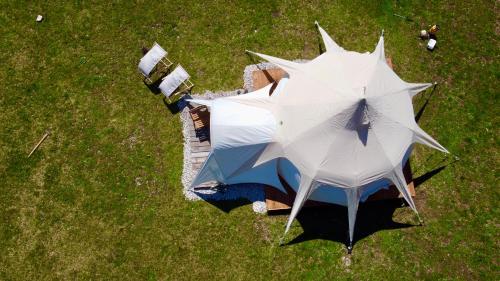 an overhead view of a white tent in the grass at Glamping Gozdna Jasa in Bovec