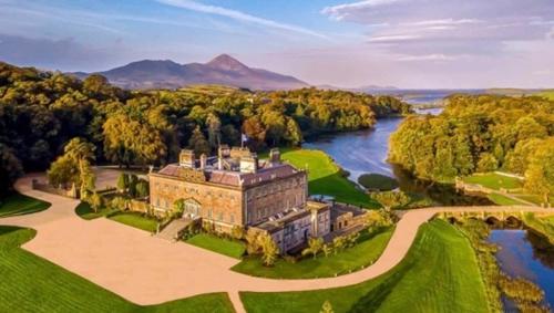 an aerial view of a large house with a river at Dun Maeve Guesthouse in Westport