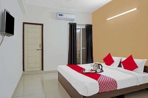 a bedroom with a bed with a tray of food on it at Super OYO Flagship Sapphire Homes Stay in Hinjewadi