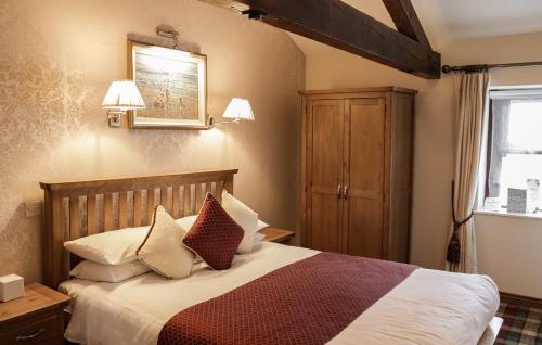 a bedroom with a bed and a cabinet and a window at Oranmore in Ballymena