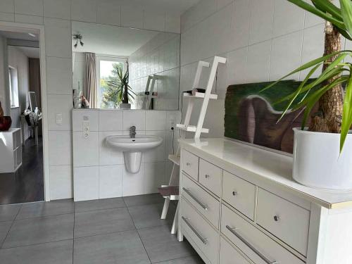 a bathroom with a sink and a toilet and a mirror at House Susanne in Cologne