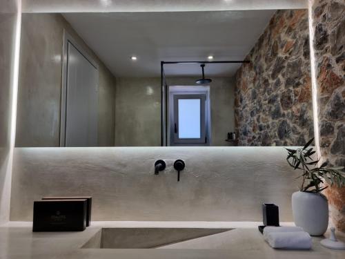 a bathroom with a sink and a mirror at Stone build suite with private pool in Kolios