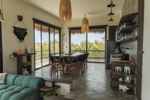 a living room with a blue couch and a table at Luxury Villa Ocean View "Casa Mar" in Holbox Island