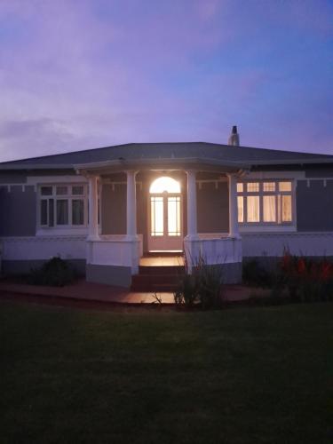 a house with a light on the front of it at The Cradle's Rest Guest House in Krugersdorp