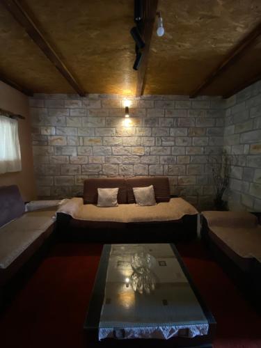 a room with a bed and a table in it at Skadar Lake Apartment Nikola I in Virpazar