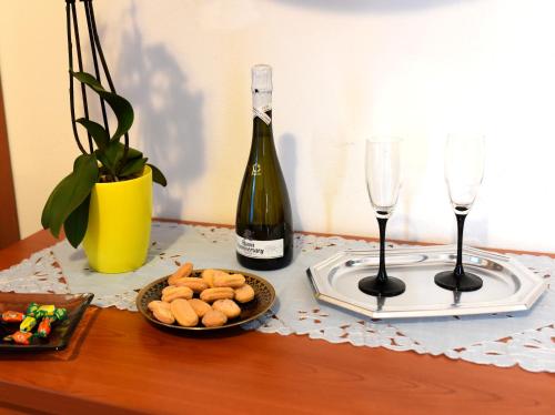 a table with a bottle of wine and two glasses at Hotel California in Carloforte