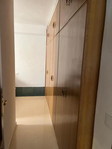 a hallway with a door to a room with a hallway at El Torreón 2 in Lora del Río