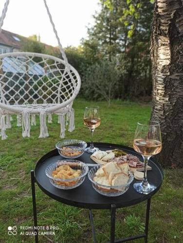 - une table noire avec des verres de vin et de la nourriture dans l'établissement Maison entière, circuit 24h du Mans, au Mans