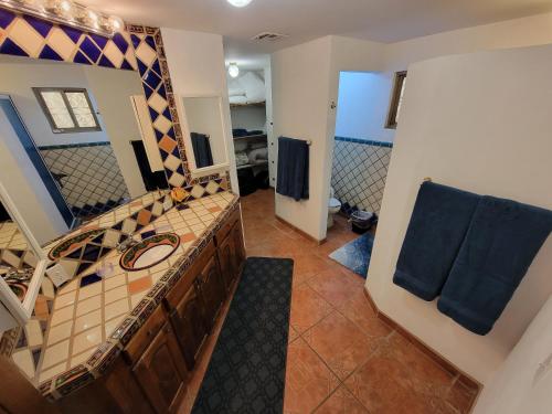a bathroom with a sink and a large mirror at Casa Medusa at Cholla Bay Rocky Point by Castaways in Puerto Peñasco