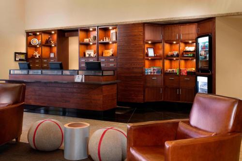 un bar dans un restaurant avec des chaises et des tables en cuir dans l'établissement Four Points by Sheraton Hotel & Conference Centre Gatineau-Ottawa, à Gatineau