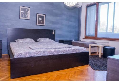 a bedroom with a large bed in a room at Luxury apartment on the first line to the sea in Burgas City