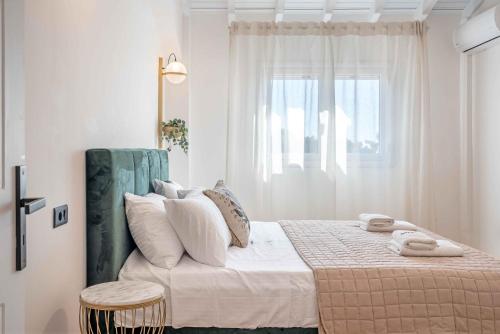 a bedroom with a large bed with a window at Grouzi Loft in Skala Kefalonias