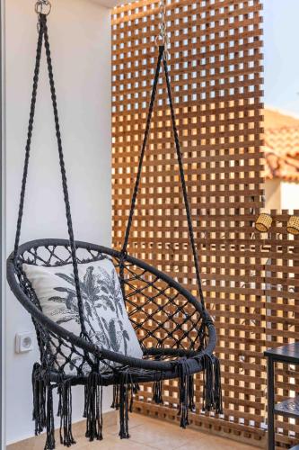 a hanging chair with a pillow in a room at Grouzi Loft in Skala Kefalonias