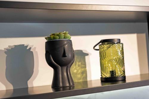 a shelf with a vase and a can on it at Grouzi Loft in Skala Kefalonias