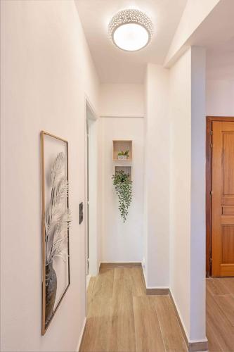 a hallway with white walls and a picture on the wall at Grouzi Loft in Skala Kefalonias