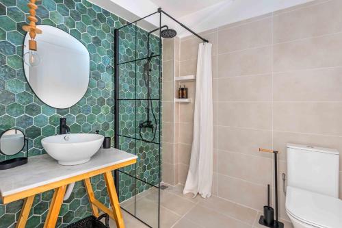 a bathroom with a sink and a shower at Grouzi Loft in Skala Kefalonias