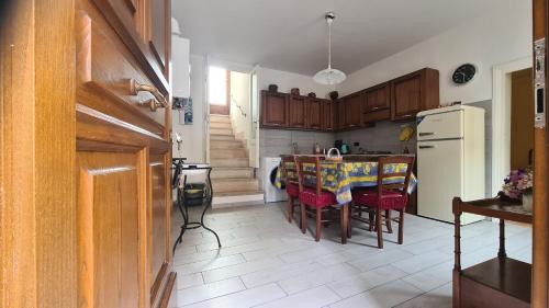 a kitchen with a table and chairs and a refrigerator at Amazing Lake View in Castel di Tora